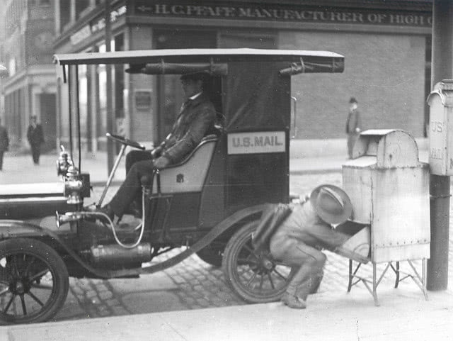 City letter carrier retrieving mail from a city collection box City letter carrier retrieving mail from a city collection box